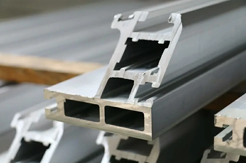 Production of extruded profiles for aluminum alloy door and window structures